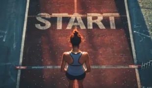 Female athlete stands on the starting line of the world athletics start