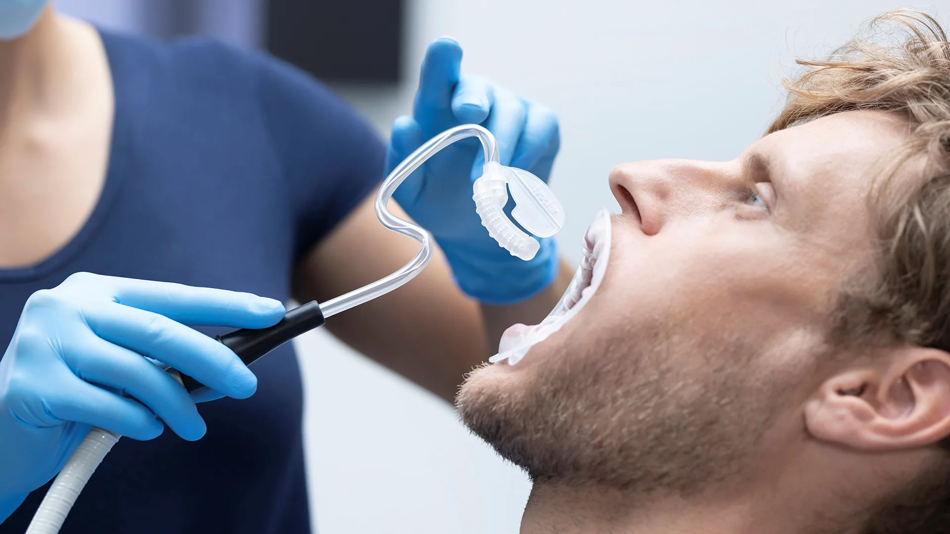 Ein Mann ist beim Zahnarzt und wird untersucht