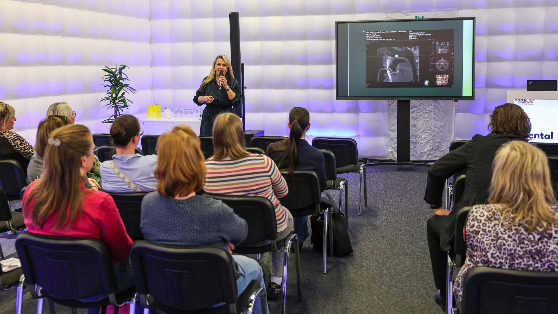 Referentin hält auf den infotagen FACHDENTAL einen Vortag vor vielen Besuchern.
