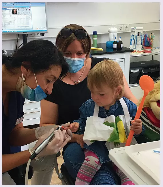 Abb. 1: Auf dem Schoß der Bezugsperson macht der Zahnarztbesuch oft weniger Angst.