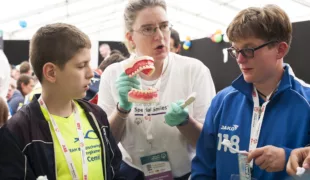 Zahnmedizinisches Prophylaxeprogramm Special Smiles auf den Special Olympics 2016 in Hannover: Die Athleten Cemil Sevimli, Friedrich-von-Bodelschwingh-Schule Bergkamen (gelb), und Kirstin Speckmann, Martinshof Bremen (blau), bei der Zahnpflegeinstruktion.