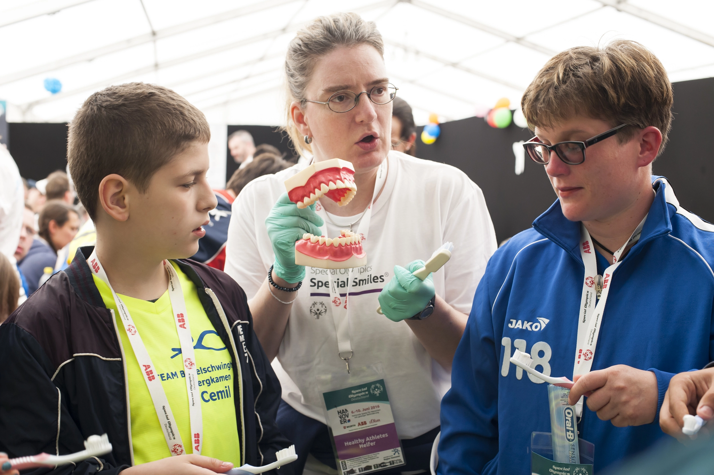 Zahnmedizinisches Prophylaxeprogramm Special Smiles auf den Special Olympics 2016 in Hannover: Die Athleten Cemil Sevimli, Friedrich-von-Bodelschwingh-Schule Bergkamen (gelb), und Kirstin Speckmann, Martinshof Bremen (blau), bei der Zahnpflegeinstruktion.