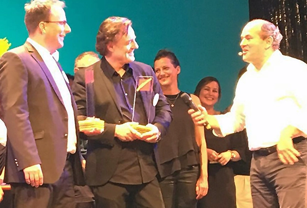 Den Preis nahm Georg Burr (Product Marketing Manager, Dürr Dental) und Robert Mils (Geschäftsführung, Leonhardt & Kern Werbeagentur) von Wolfram Kons (Comprix-Moderator) entgegen (v.l.).